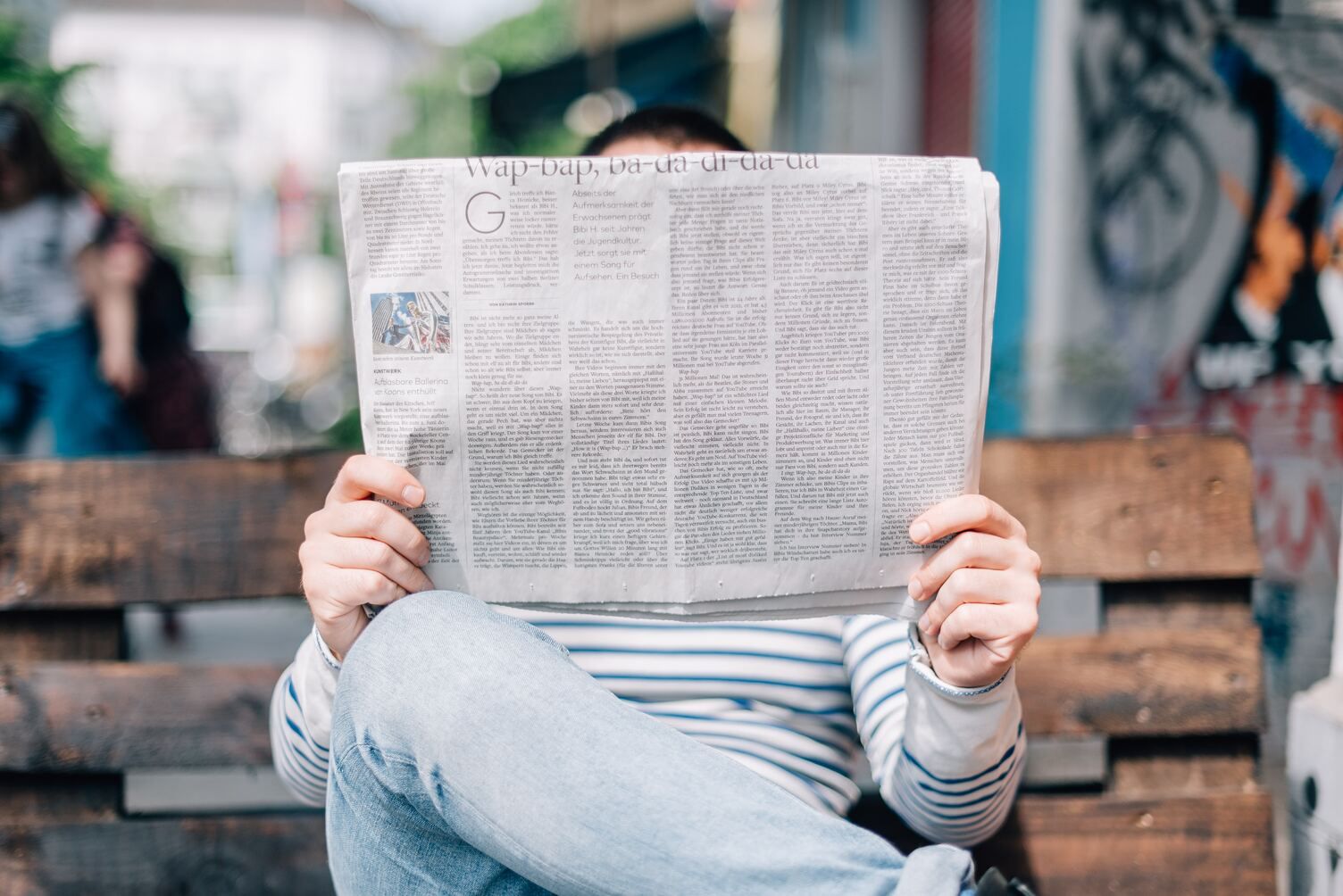 guy-sitting-on-the-lawn-reading-gazette.jpg