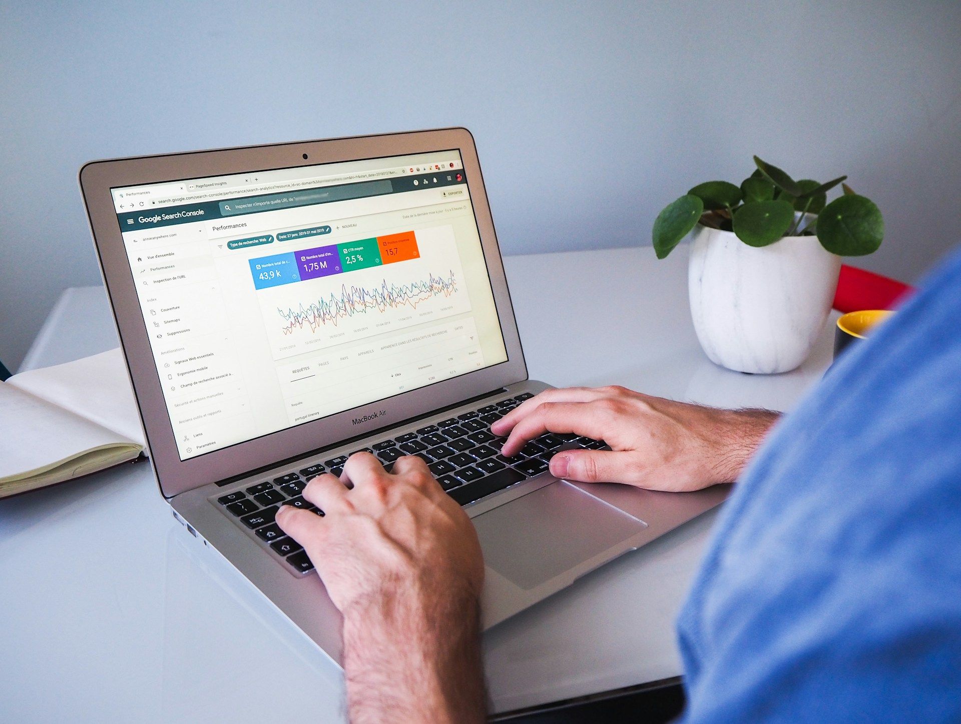 person analyzing Google Ads data on MacBook Air.