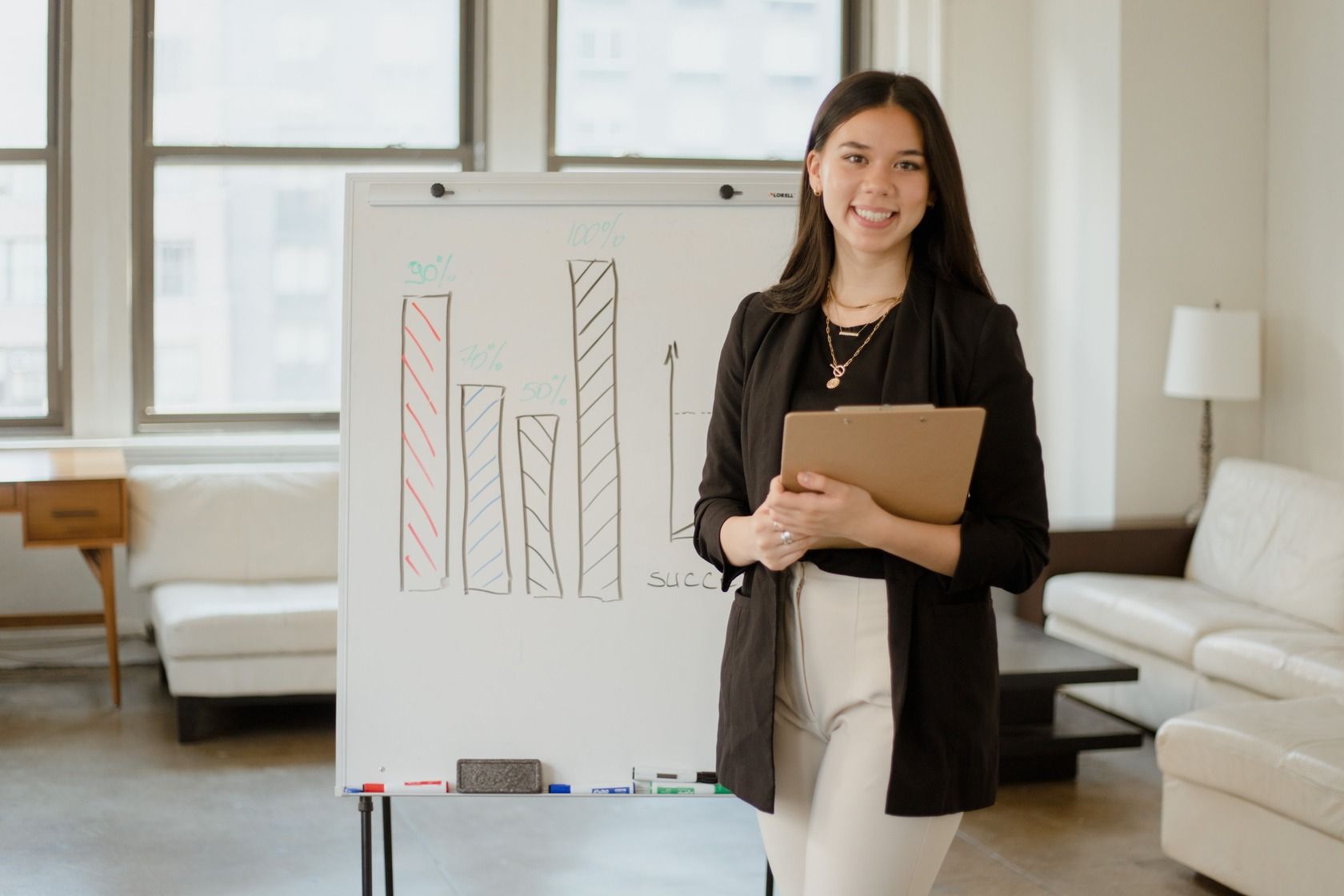 smiling-woman-standing-before-the-table-which-is-a-chart.jpg