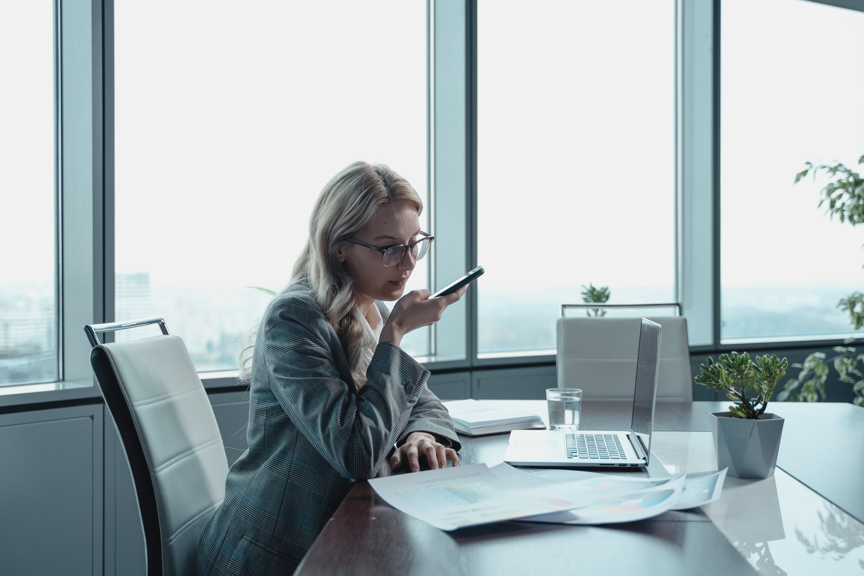 women-working-in-the-office-with-smartphone-in-hand.jpg